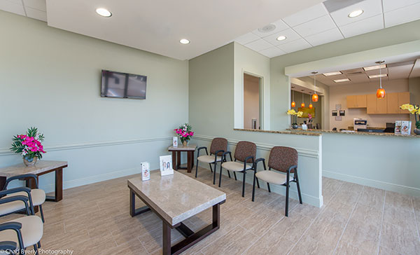 Waiting Area with Reception Desk in the Background at Sage Dental Oviedo