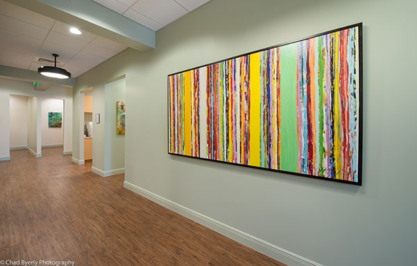 Hallway View Showing Colorful Artwork at Sage Dental in Oviedo, FL
